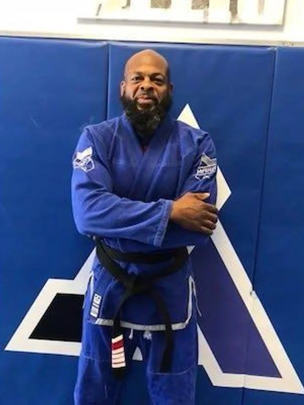 Coach Tyrone Elijah, owner and head instructor of Elijah Brazilian Jiu Jitsu Academy in Union, New Jersey, in a blue gi and black belt