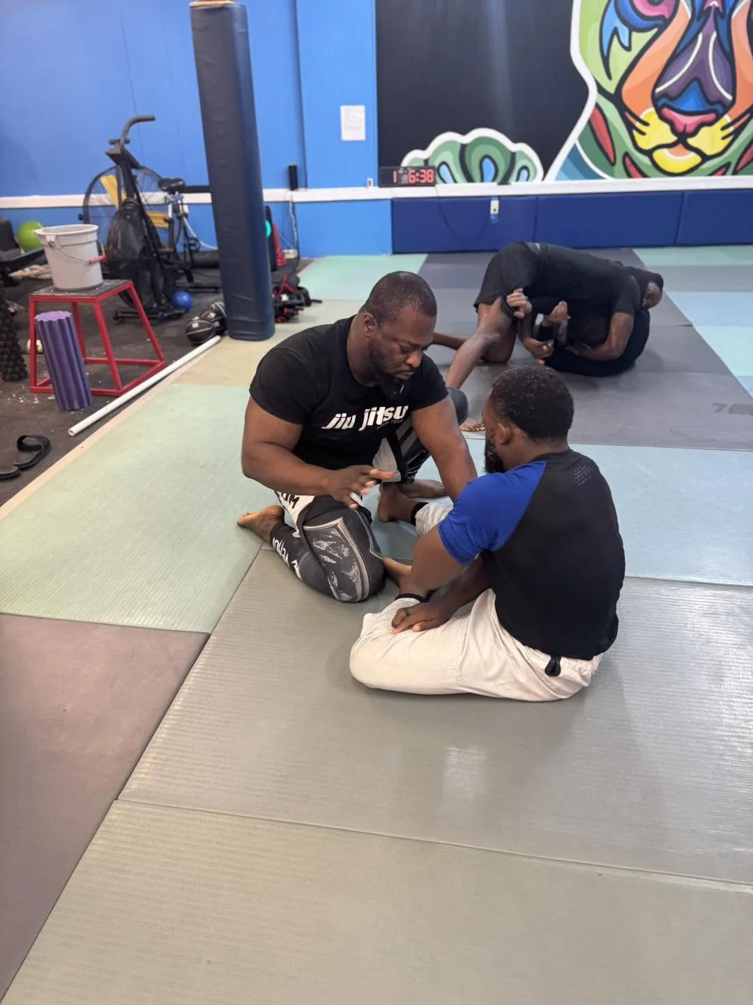 Two adult students drilling a no-gi Brazilian Jiu Jitsu technique on the mats at Elijah Brazilian Jiu Jitsu Academy in Union, New Jersey