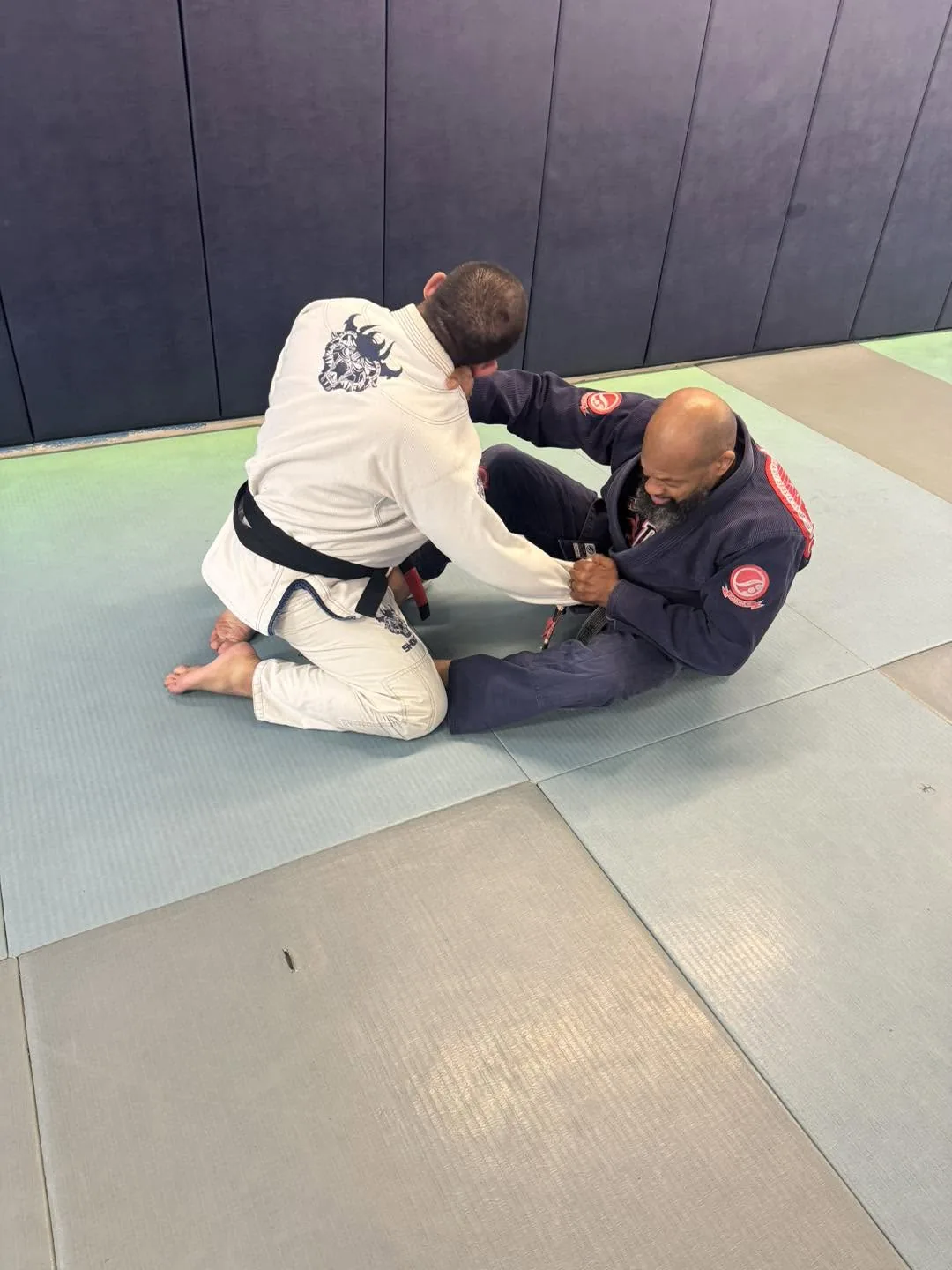 Two adult black belts working a guard pass during Brazilian Jiu Jitsu training at Elijah Brazilian Jiu Jitsu Academy in Union, New Jersey