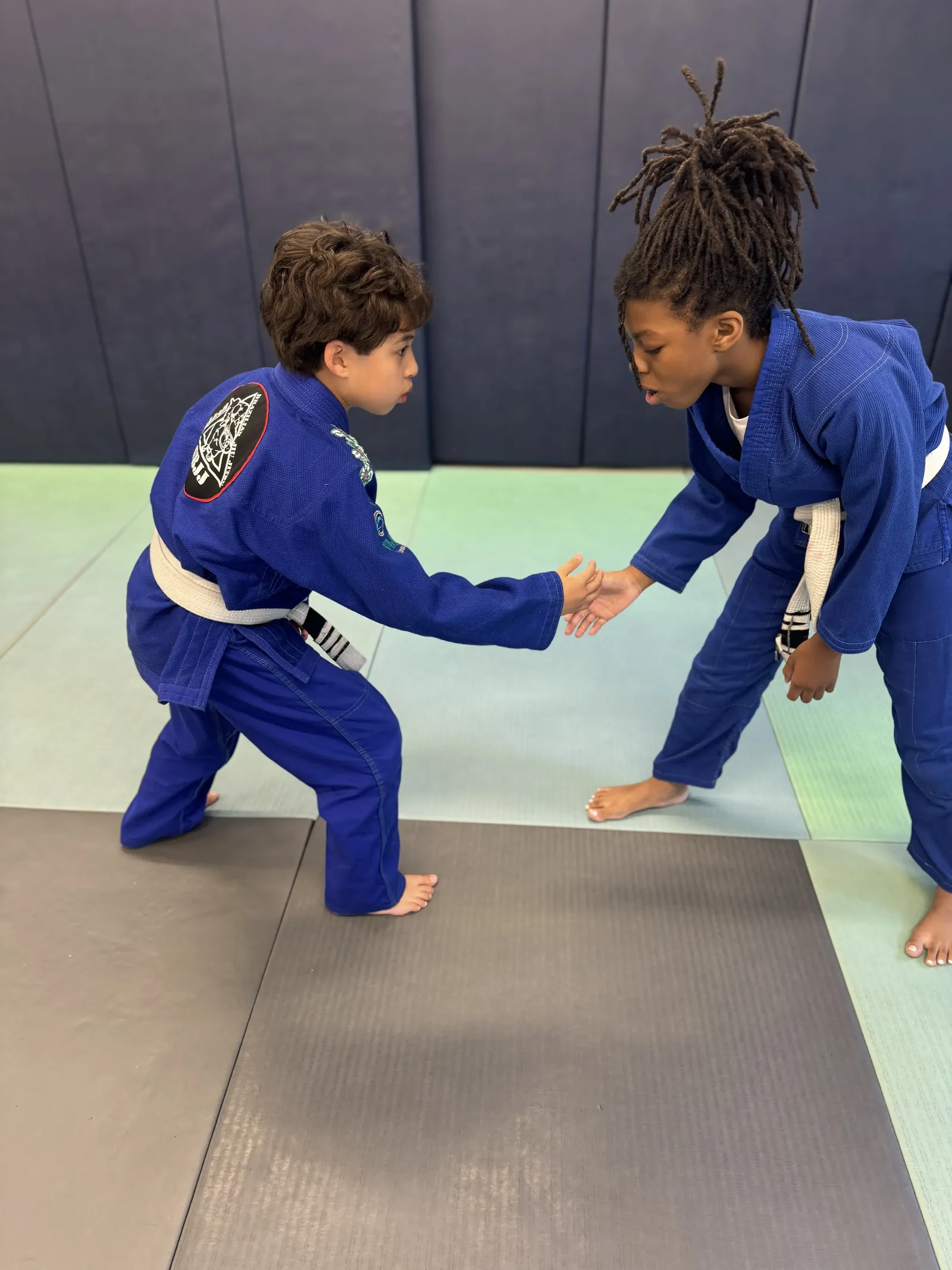 Two young students grip fighting during a kids Brazilian Jiu Jitsu class at Elijah Brazilian Jiu Jitsu Academy in Union, New Jersey