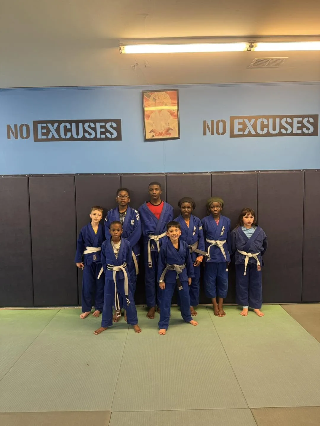 Kids Brazilian Jiu Jitsu class in blue gis together on the mats at Elijah Brazilian Jiu Jitsu Academy in Union, New Jersey